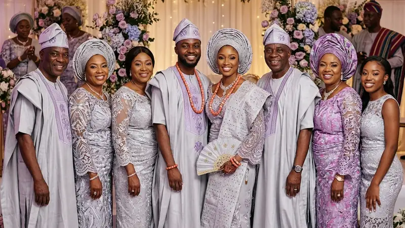 Nigerian couple in coordinated aso-oke surrounded by family wearing matching aṣọ ẹbí at a traditional wedding ceremony